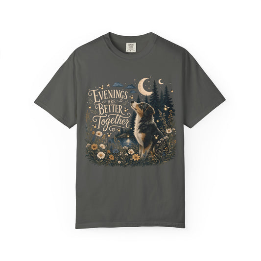 A dark gray crewneck t-shirt featuring a detailed graphic print of an Australian Shepherd dog looking up at a crescent moon in a forest, surrounded by flowers and the text 'Evenings are Better Together'.