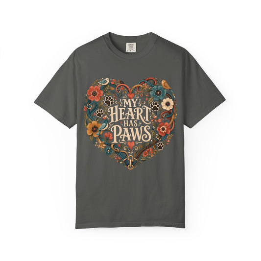 A dark gray crewneck t-shirt featuring a colorful graphic of a heart made of flowers, paw prints, and the text 'MY HEART HAS PAWS' in a vintage font.