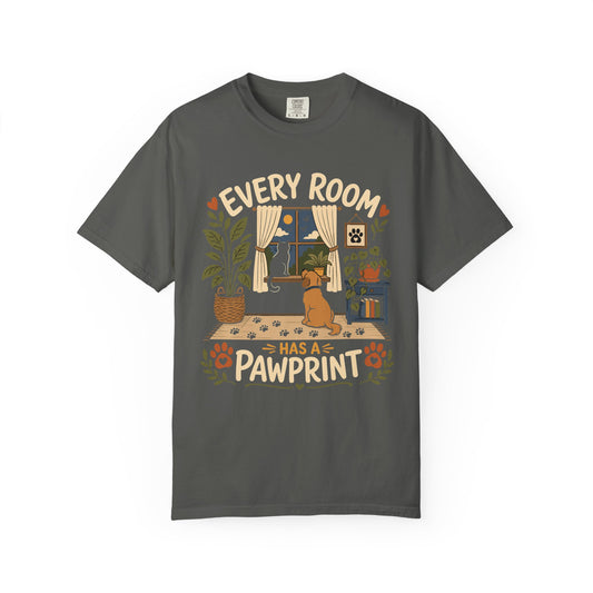 A dark gray crewneck t-shirt featuring a colorful graphic print of a dog sitting in front of a window with the text 'EVERY ROOM HAS A PAWPRINT' written around it.
